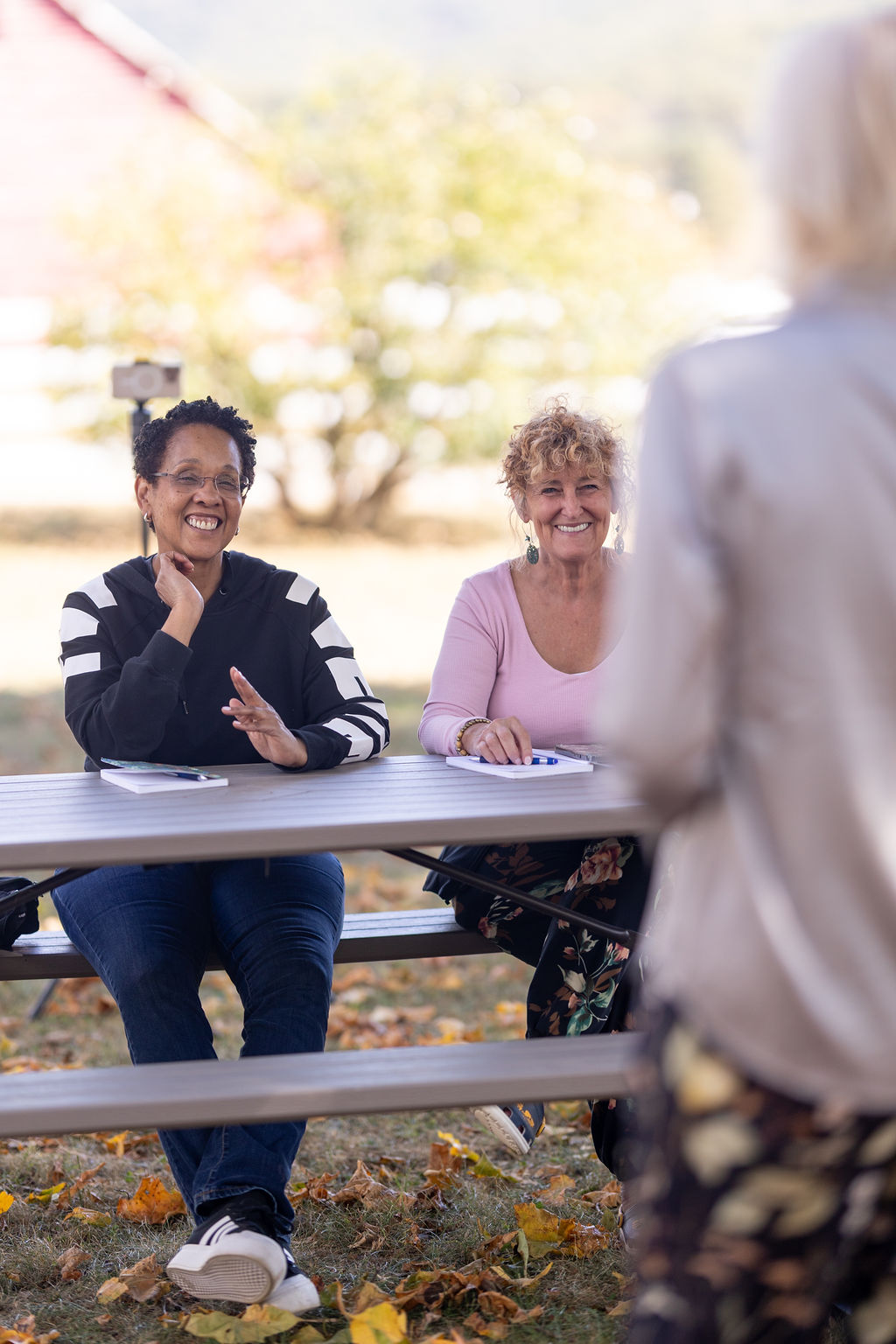 A working session outdoors, participants taking notes