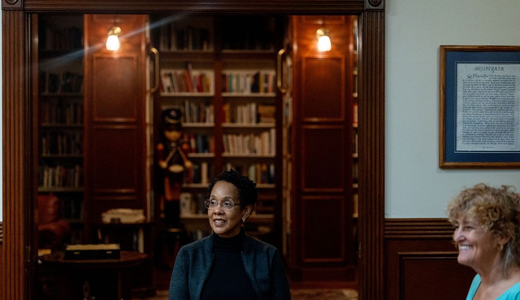 Two participants in conversation during a facilitated session in a library setting