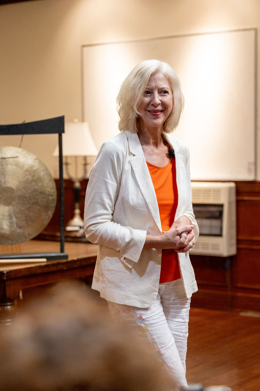 Yvonne Cole leading a Reiki Essence session, gong visible behind her